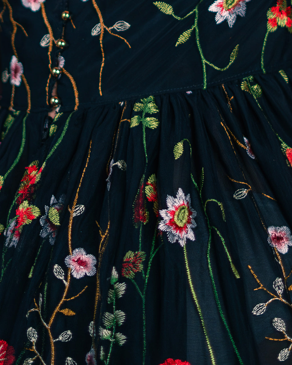 Black dress with floral embroidery and butterfly details on a blurred background [color_id:black] 