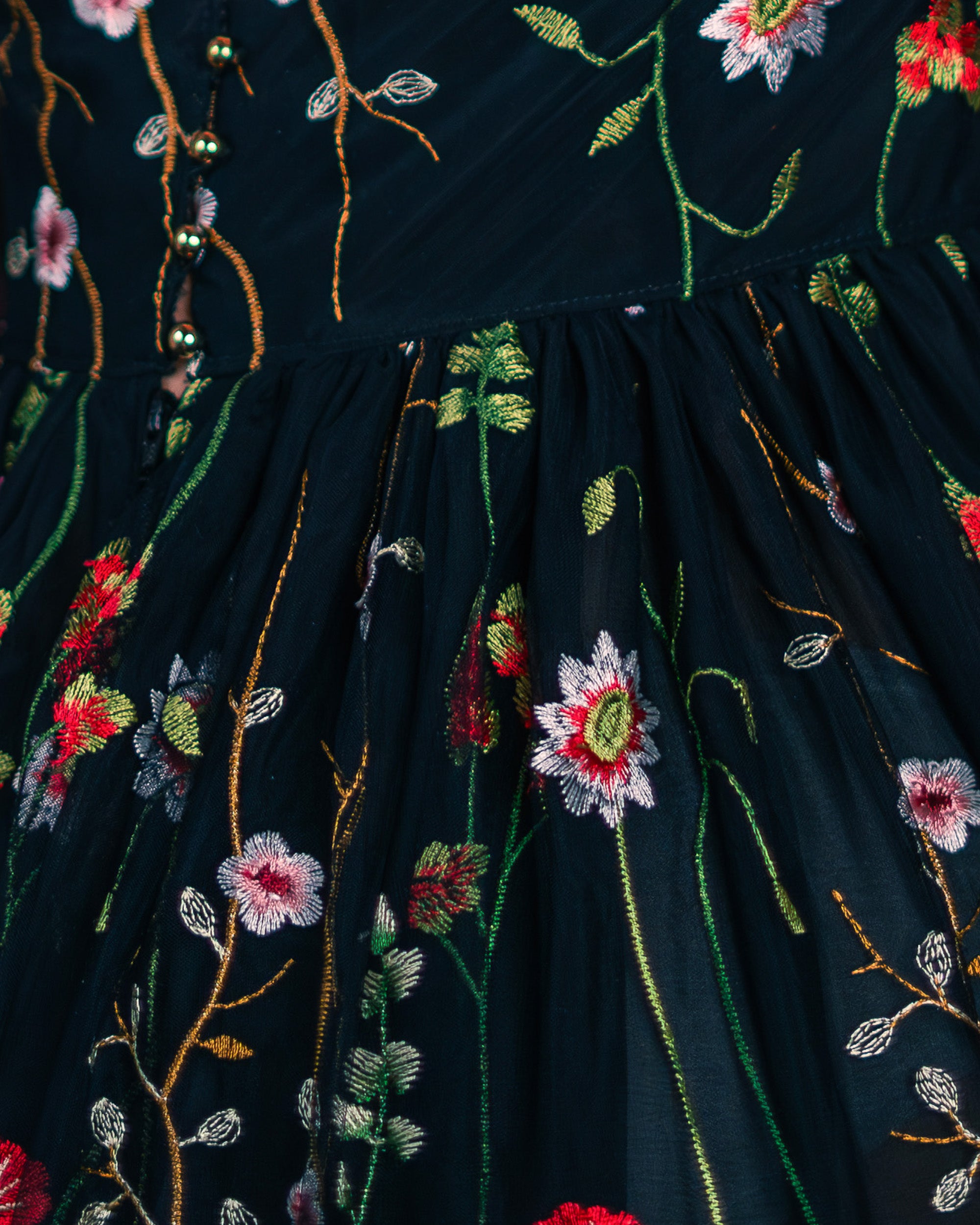 Black dress with floral embroidery and butterfly details on a blurred background [color_id:black] 