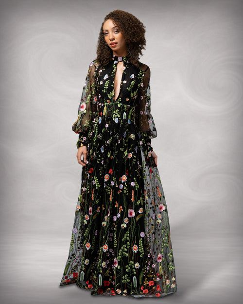 Woman wearing a black floral dress against a gray background [color_id:black] [hero]