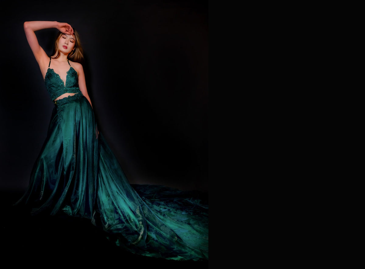 Woman wearing a one-of-one emerald couture gown