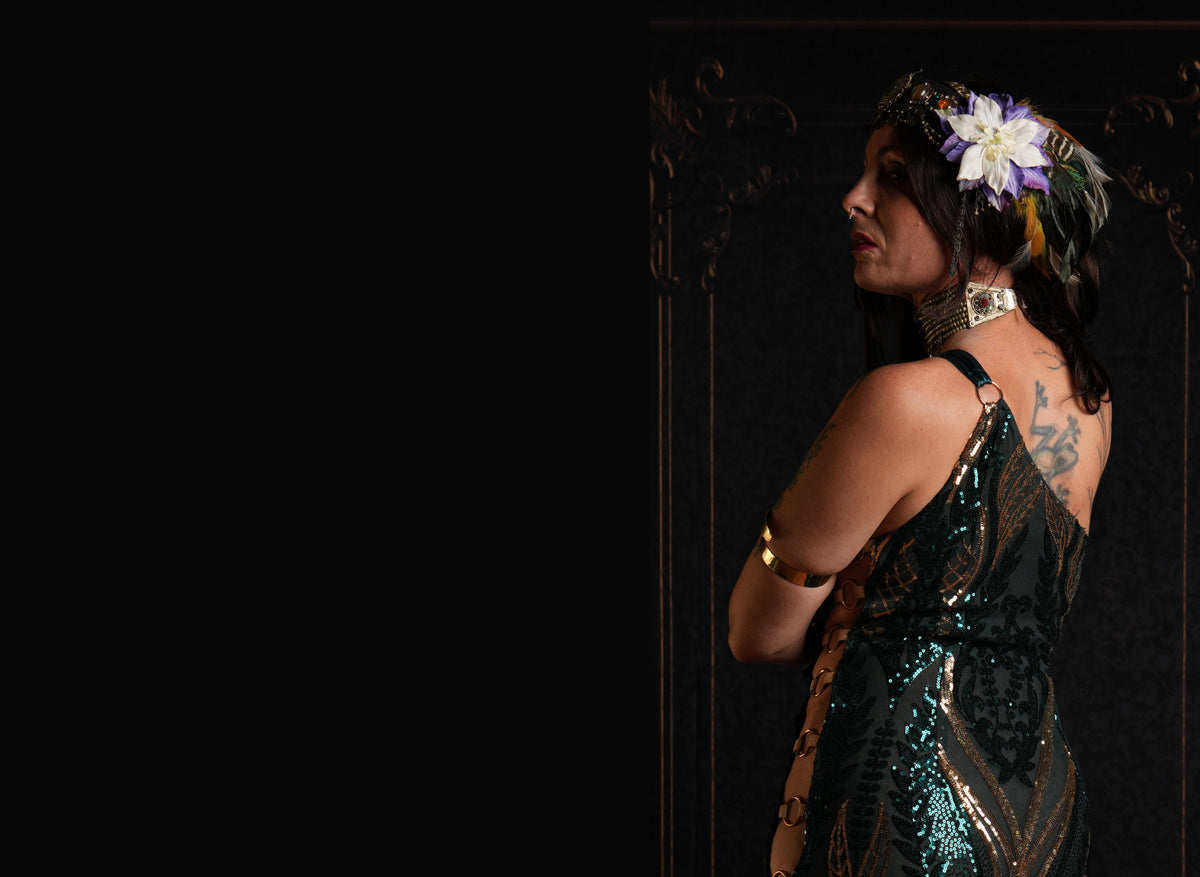 Anna Flowers wearing a black sequined dress and floral headpiece