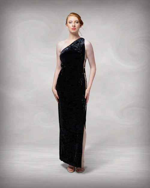 Woman wearing a black one-shoulder evening gown against a neutral background [color_id:black]