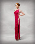 Woman wearing a red one-shoulder evening gown against a gray background [color_id:pink]