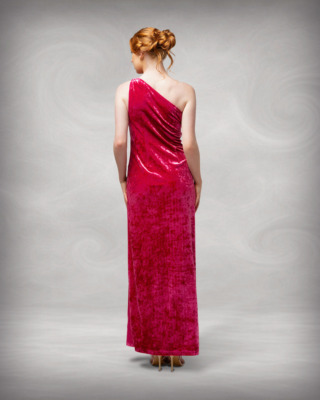 Woman wearing a one-shoulder red evening gown against a gray background [color_id:pink]